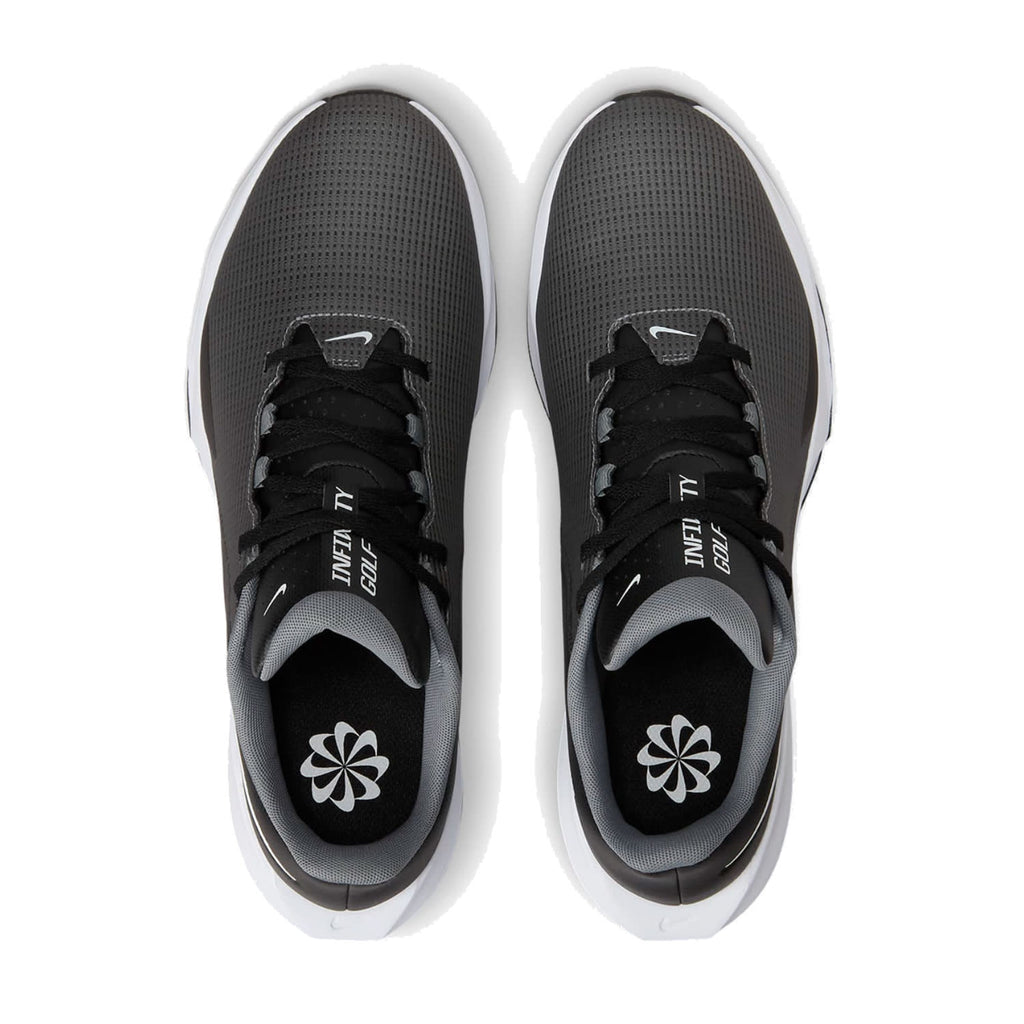 Black and white nike revolution 5 running shoes with mesh upper, rubber sole.