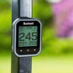 Bushnell golf gps watch with a black and silver face, featuring a sleek design.