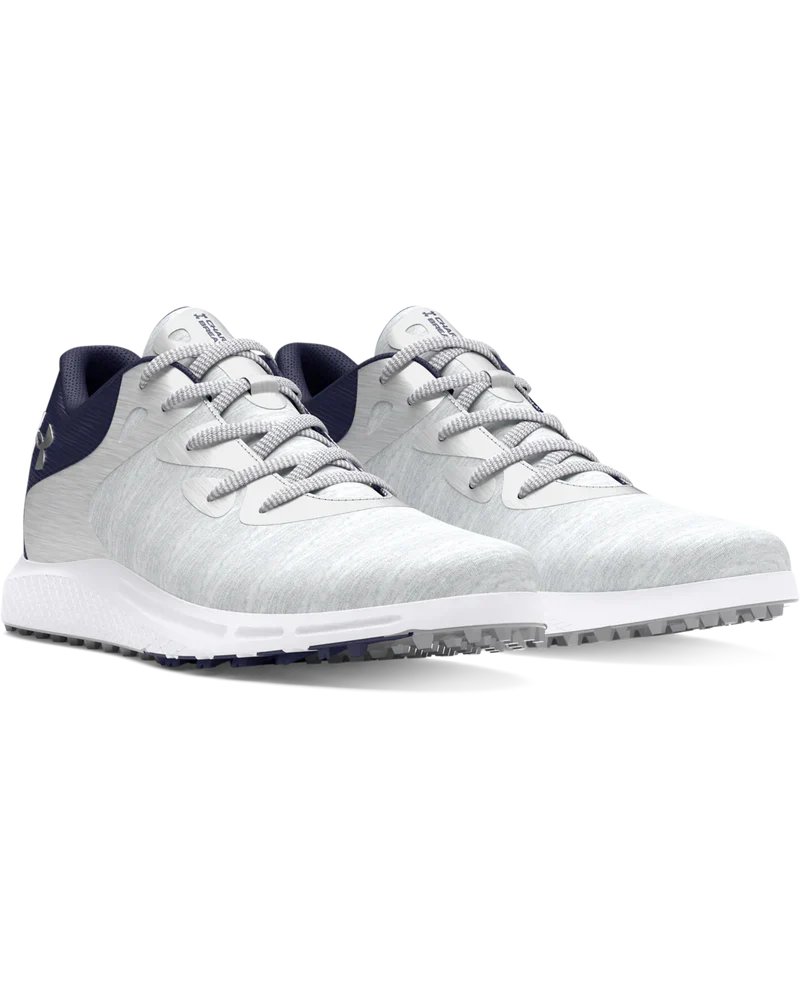 White golf shoe with navy accents and silver laces, designed for comfort and performance.